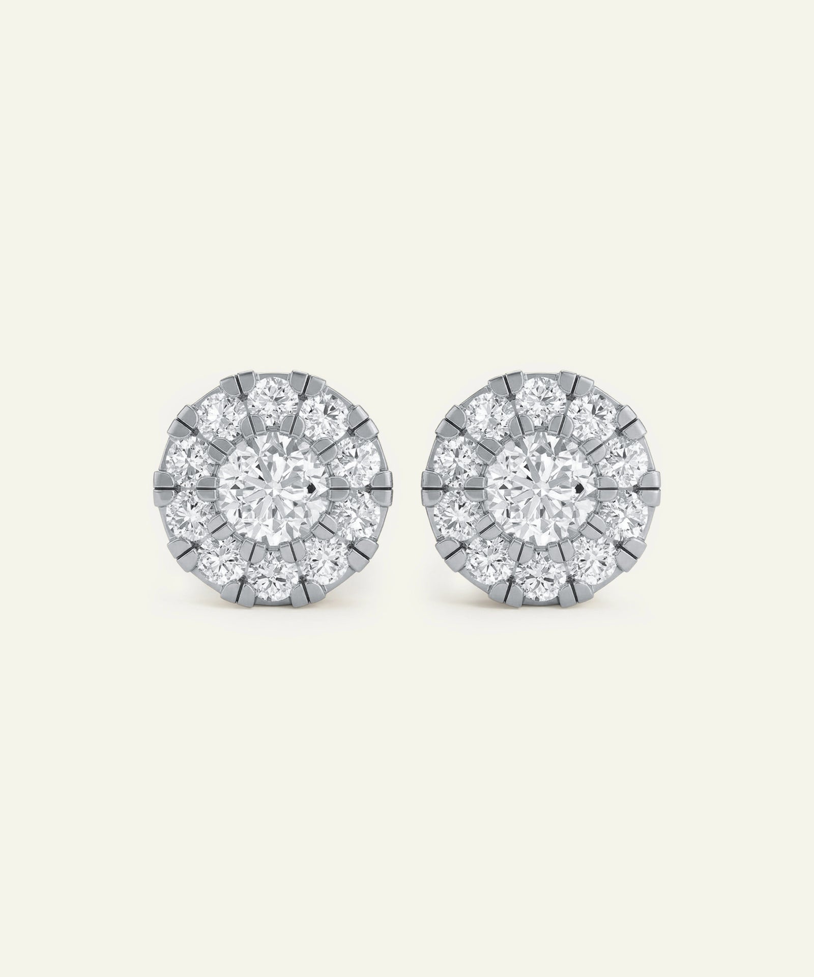 Pair of diamond stud earrings on a light gray background