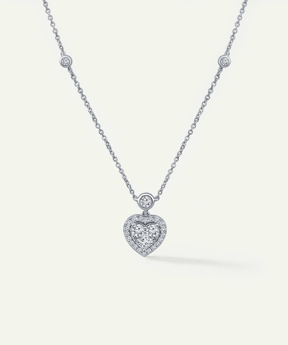 Silver necklace with a heart-shaped pendant on a white background
