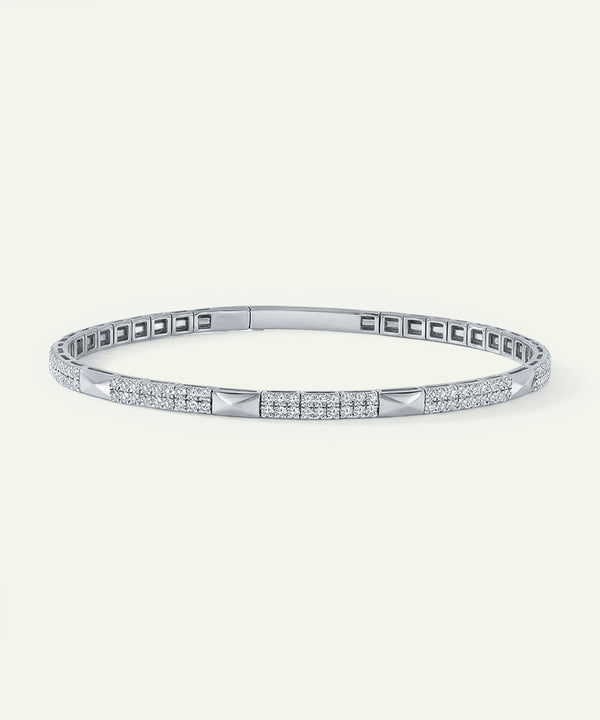 Silver bracelet with diamond accents on a white background