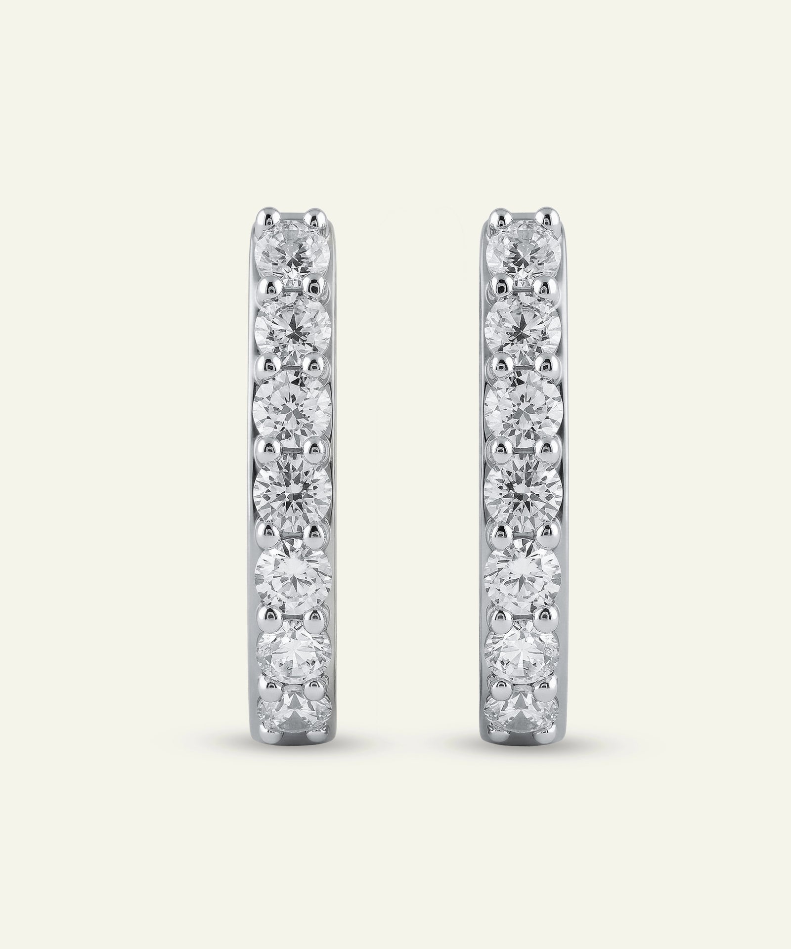 Pair of diamond hoop earrings on a light gray background