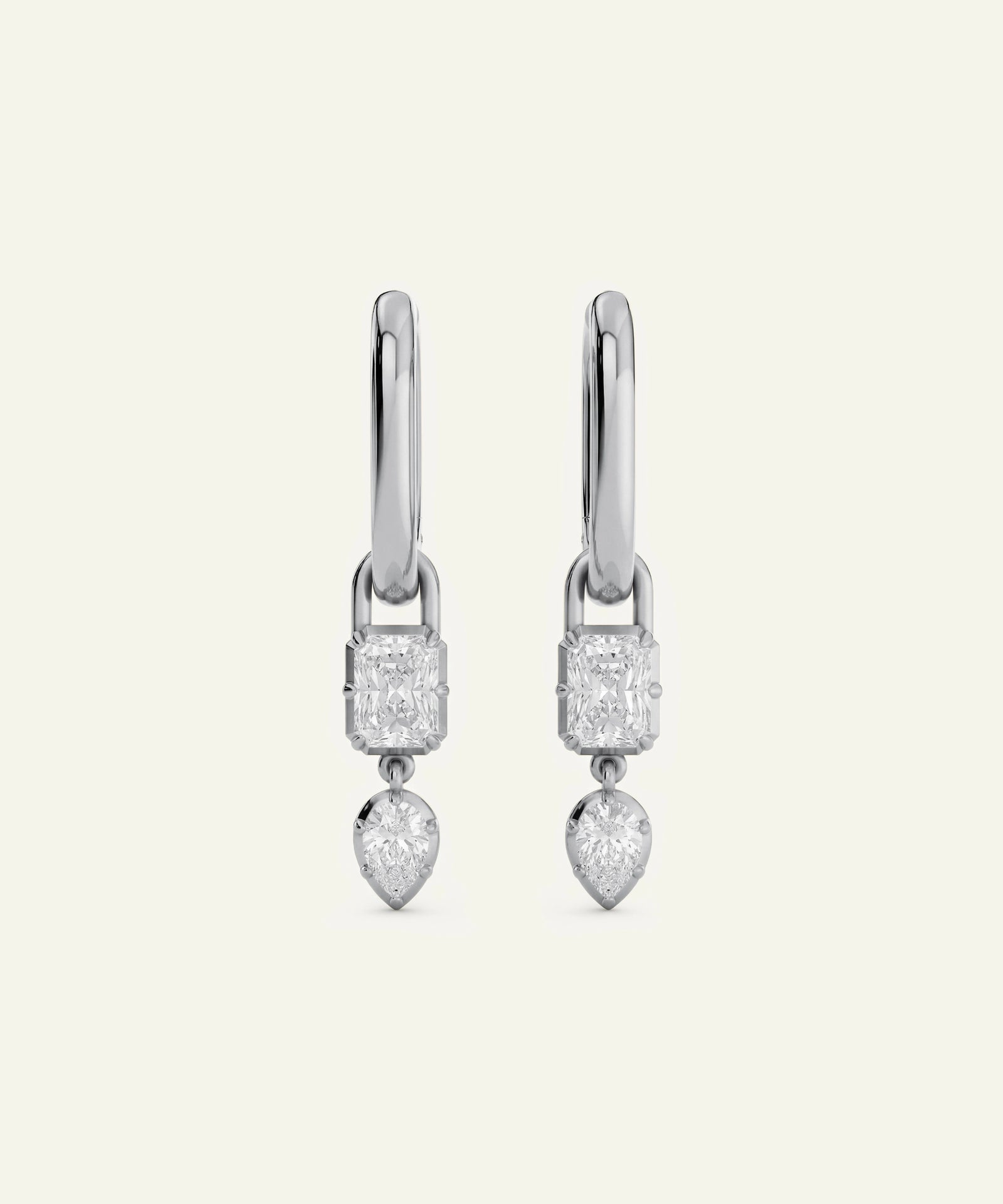 Pair of silver earrings with clear gemstones on a white background