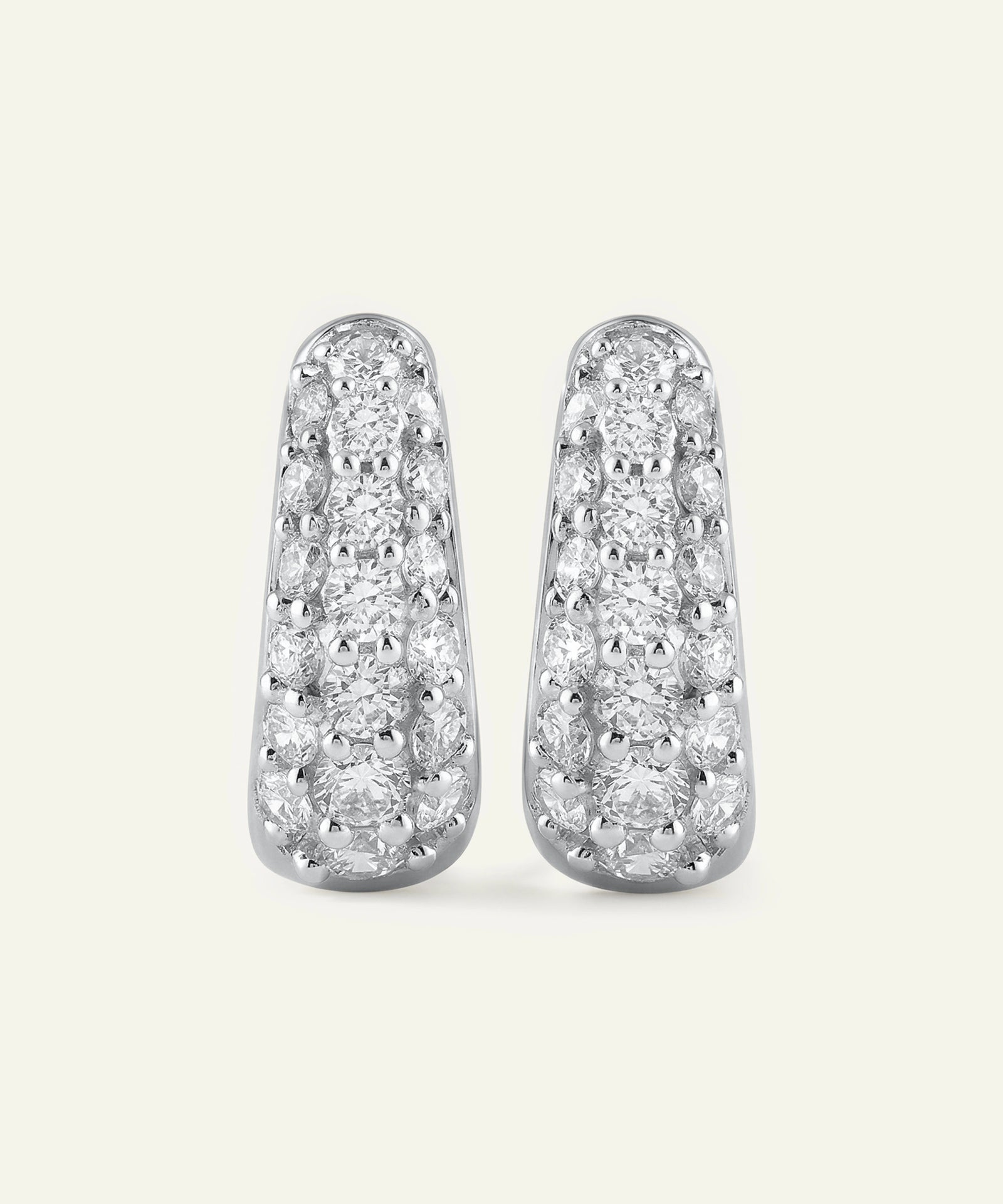 Pair of diamond earrings on a light gray background
