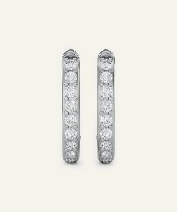Pair of diamond earrings on a light gray background