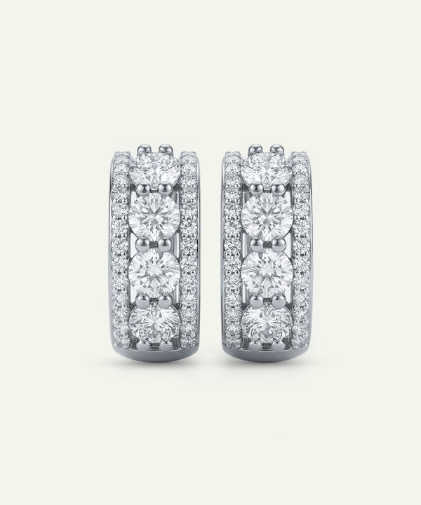 Pair of diamond earrings on a light gray background