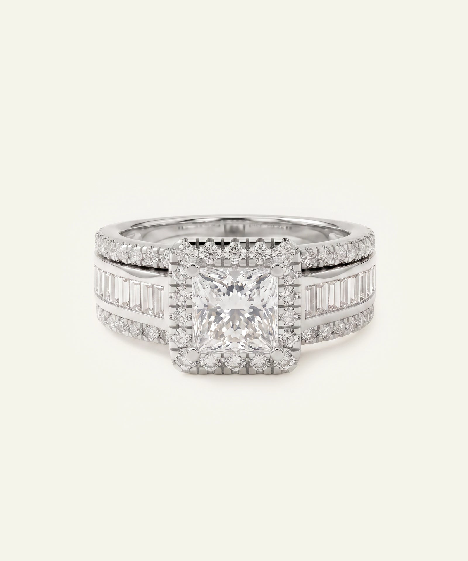 A silver-toned diamond ring featuring a central princess-cut diamond surrounded by a halo, with baguette and round diamonds set along the band, shown on a light cream background.