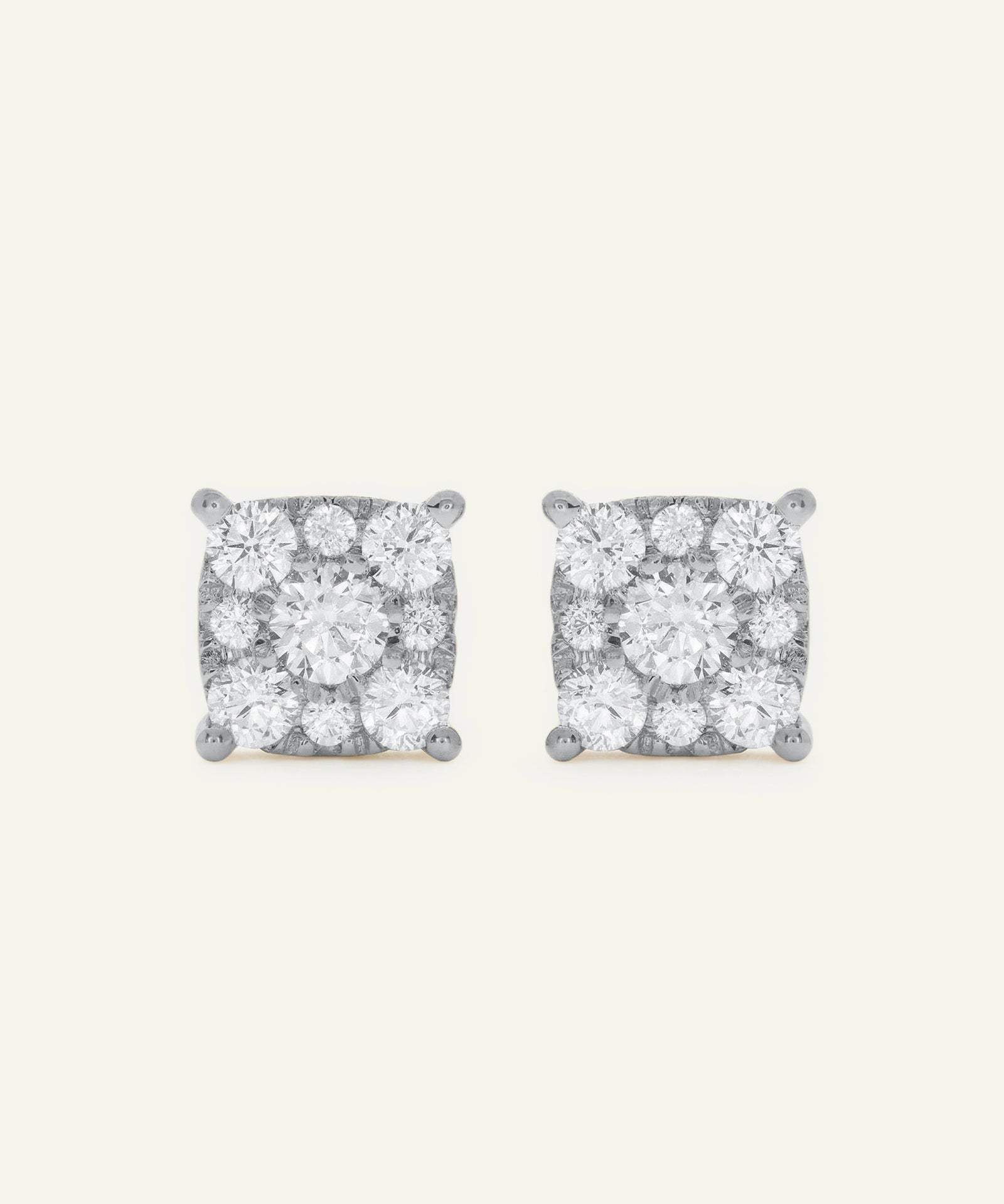 Pair of diamond stud earrings on a light gray background