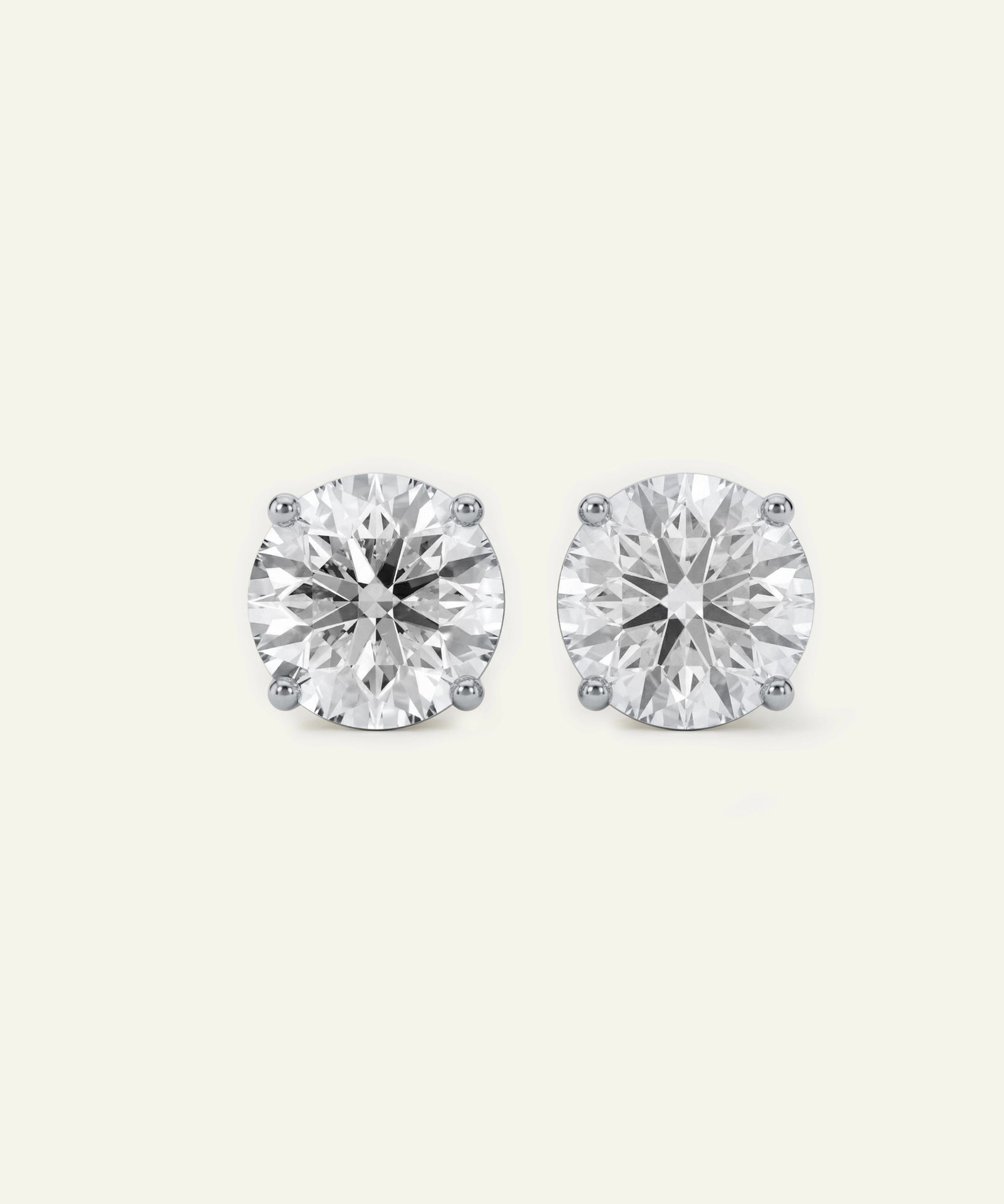 Pair of diamond stud earrings on a white background