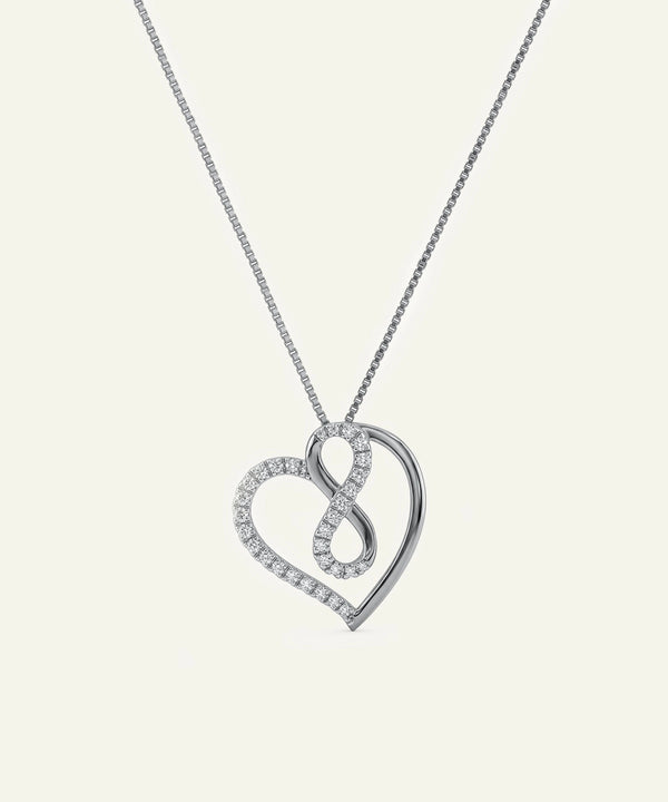 Silver heart-shaped pendant necklace on a light gray background