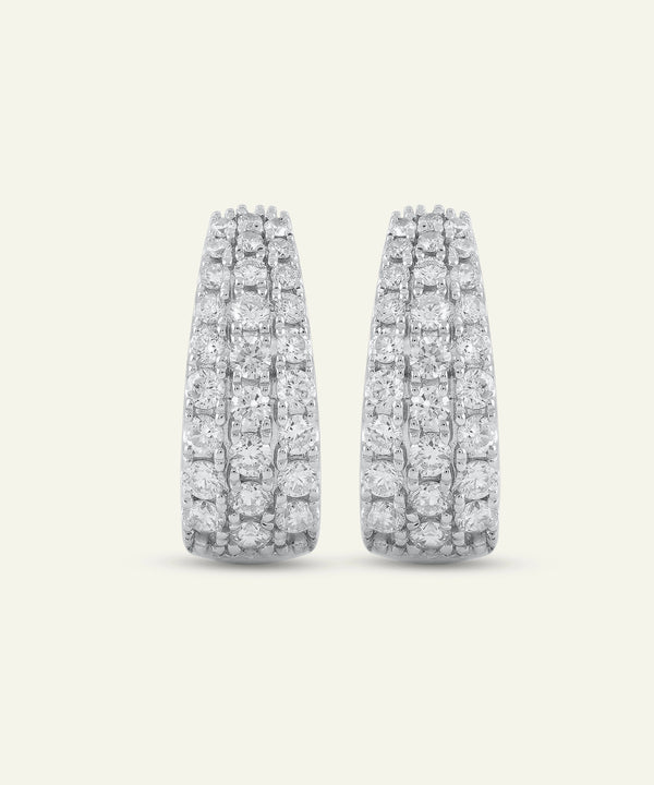 Pair of diamond earrings on a light gray background