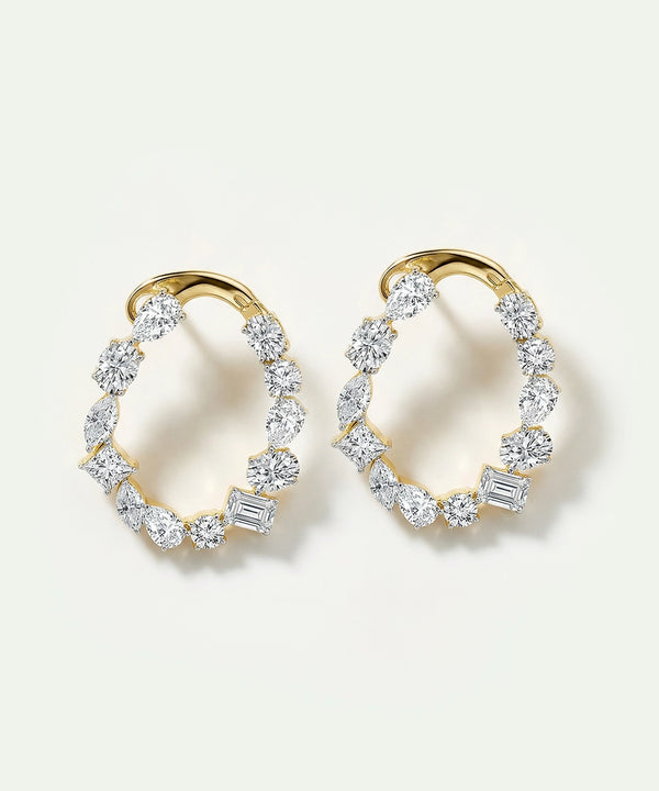 Gold hoop earrings with diamond accents on a white background