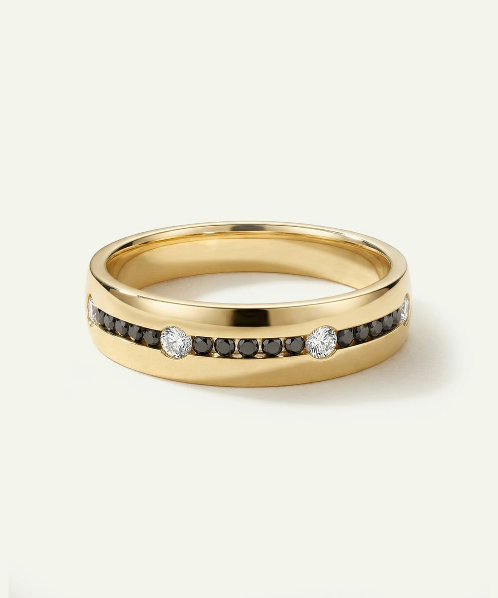 Gold ring with embedded diamonds on a light gray background
