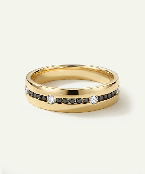 Gold ring with embedded diamonds on a light gray background