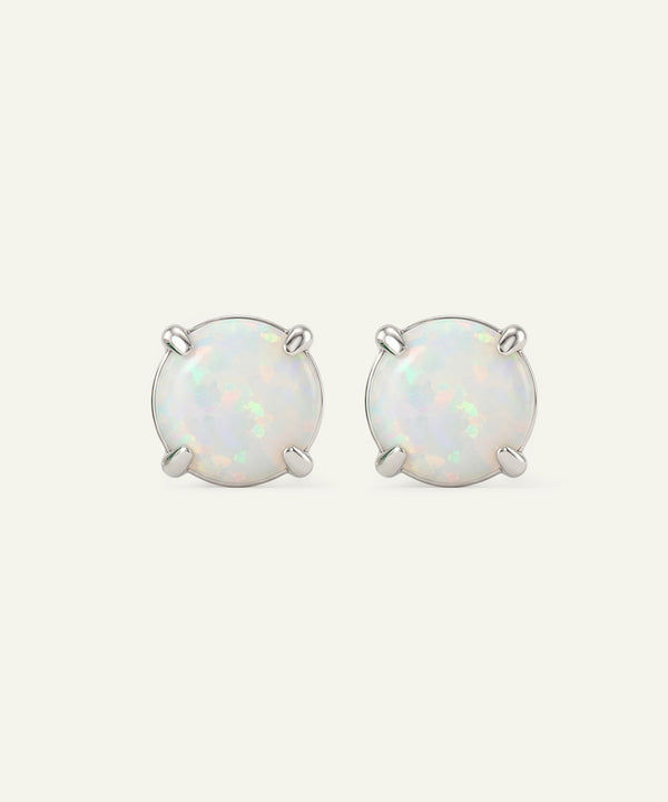 Pair of opal stud earrings on a white background