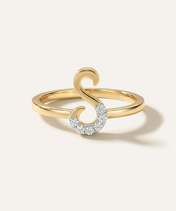 Gold ring with a unique design on a light background