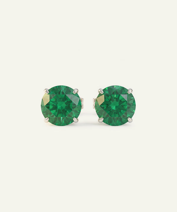 Pair of green gemstone stud earrings on a white background
