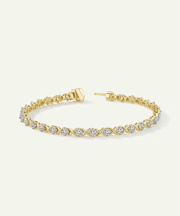 Gold bracelet with diamond accents on a light beige background