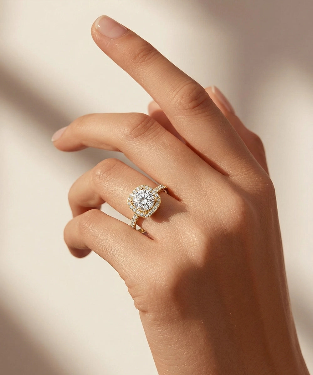 Hand wearing a diamond ring on a soft beige background
