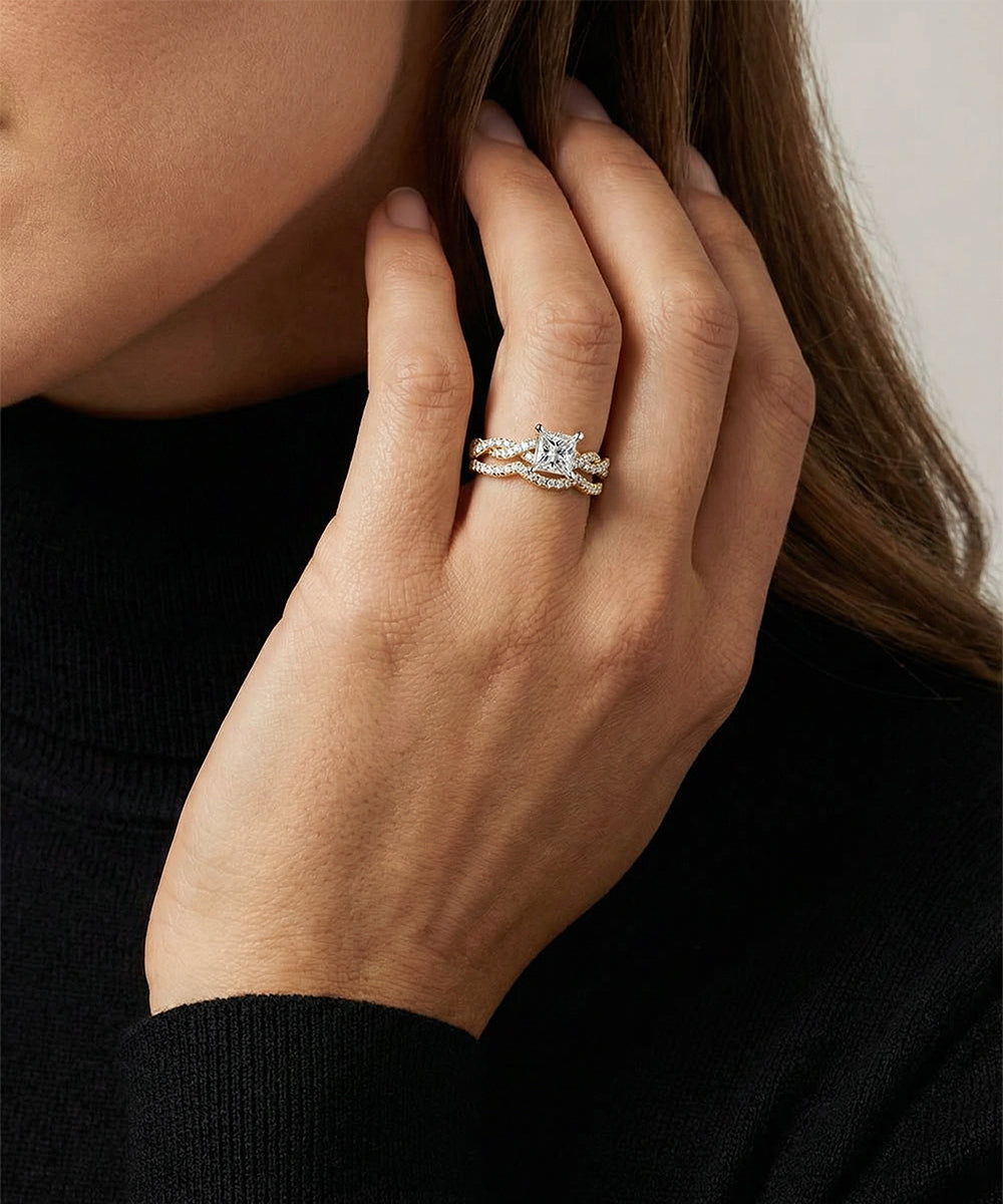 Close-up of a hand wearing a diamond ring with a blurred background