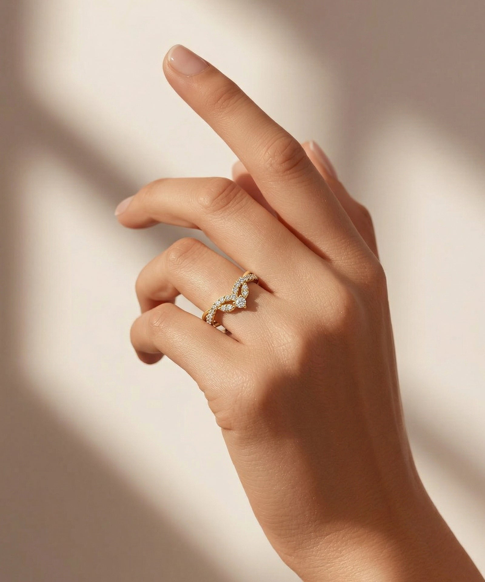 Hand wearing a diamond ring on a soft background