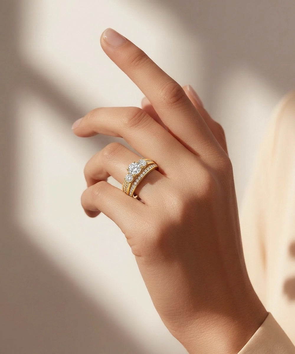 Hand wearing a gold ring with a diamond on a soft background