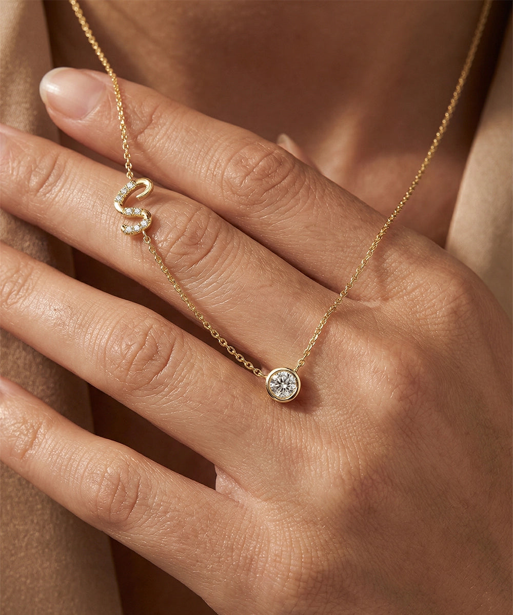 Gold ring with a diamond on a hand against a neutral background
