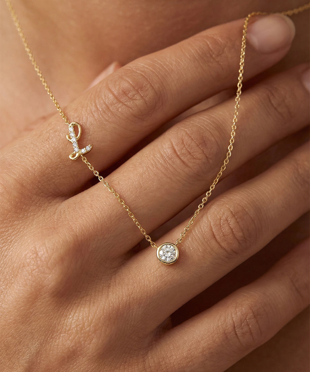 Gold necklace with a diamond pendant on a hand