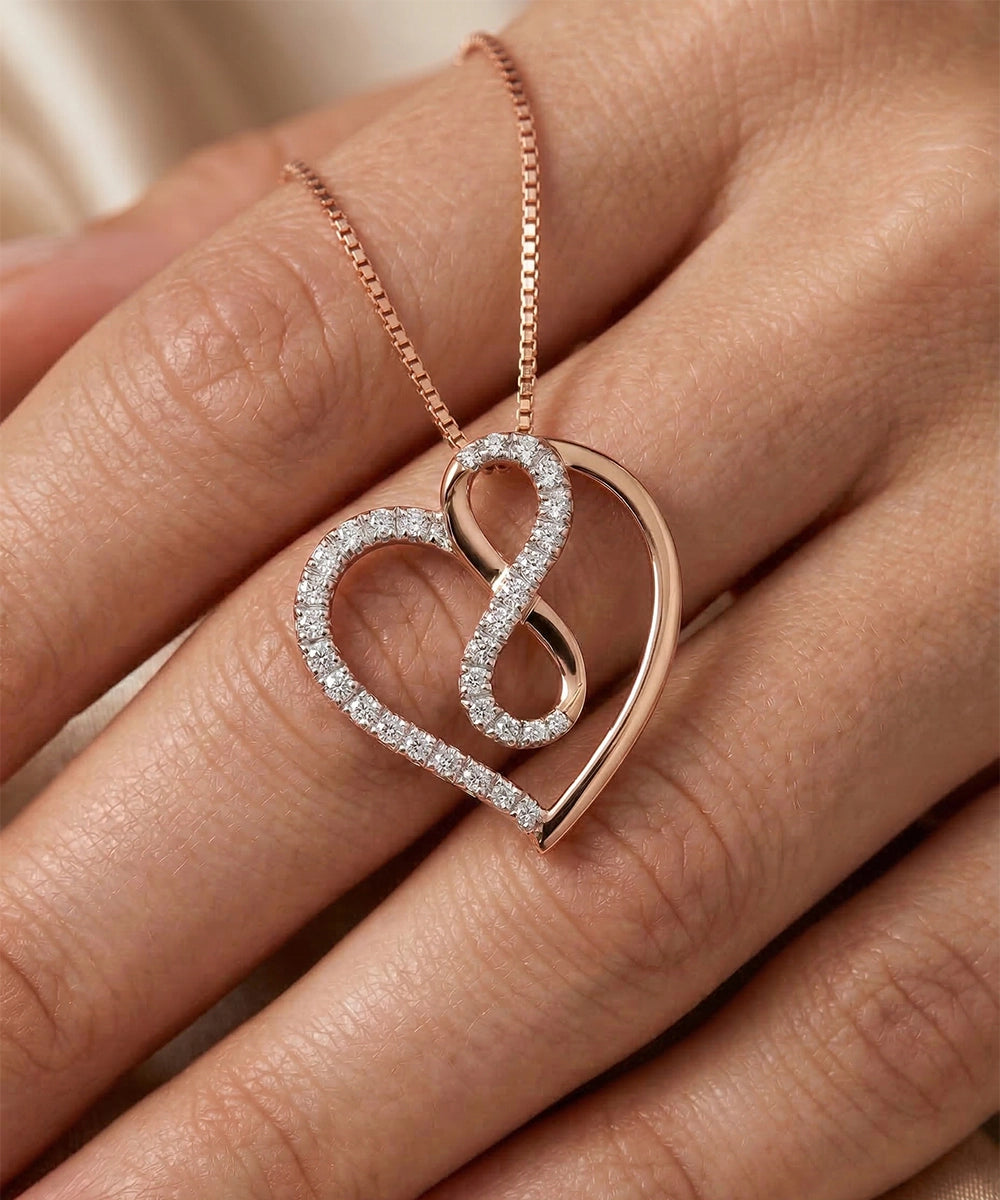 Rose gold heart-shaped necklace with diamonds on a hand