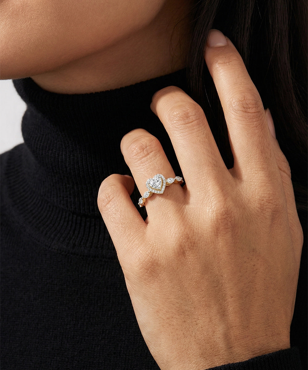 Hand wearing a diamond ring with a blurred background