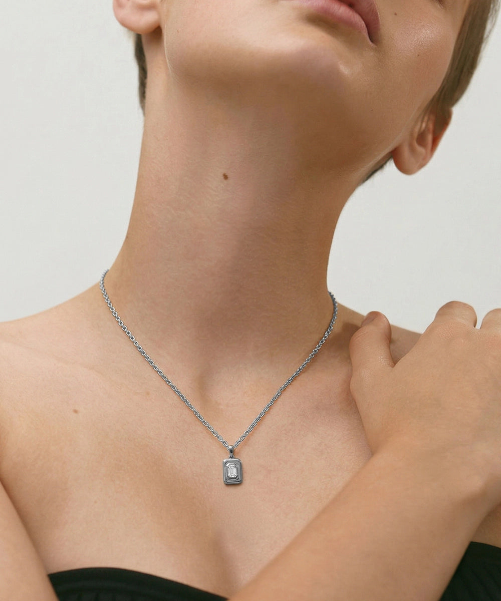 Necklace with a pendant worn by a person on a neutral background