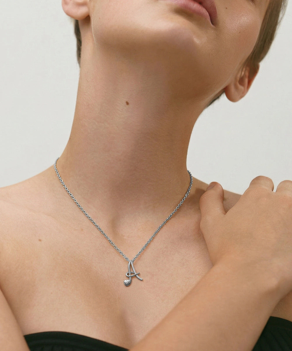 Necklace with a pendant worn by a person on a neutral background