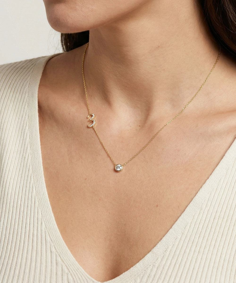 Necklace with a pendant worn by a person in a beige top