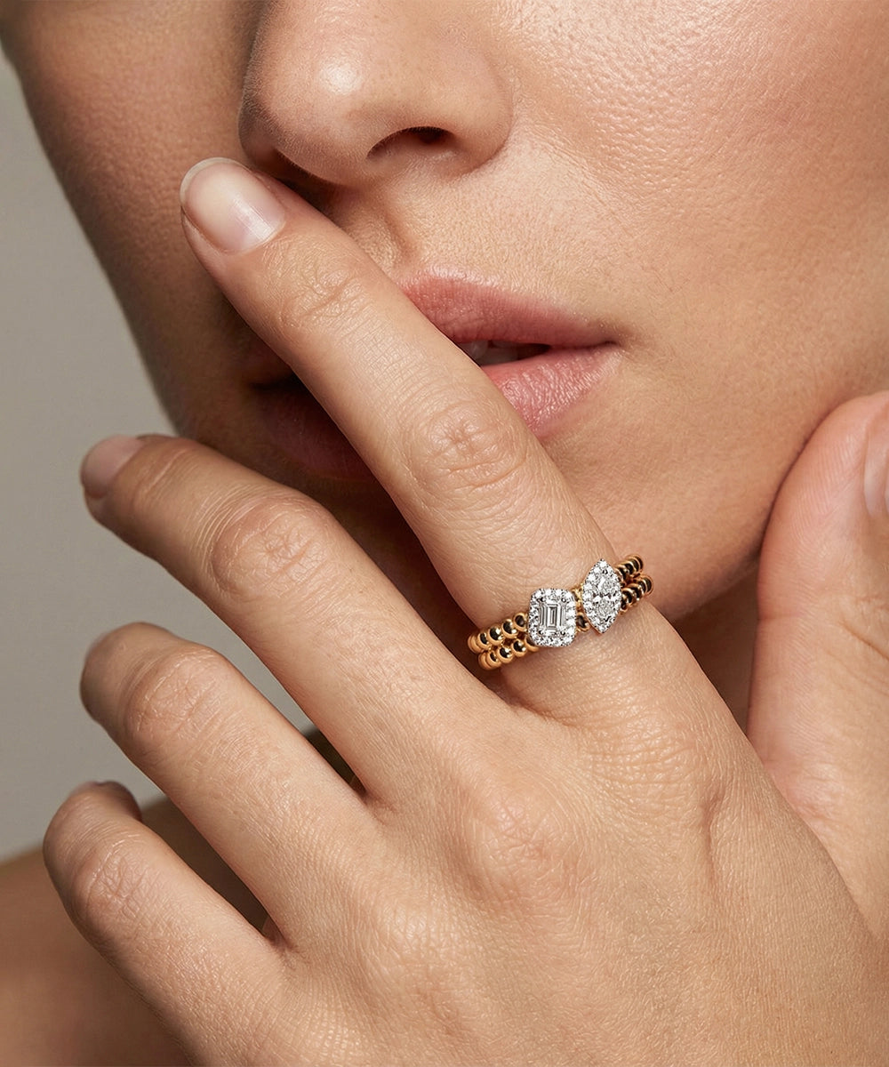 Close-up of a hand wearing a diamond ring with a neutral background