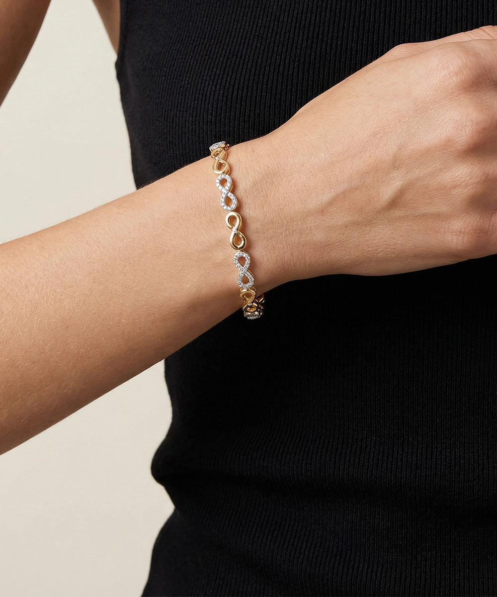 Silver bracelet on a person's wrist with a plain background