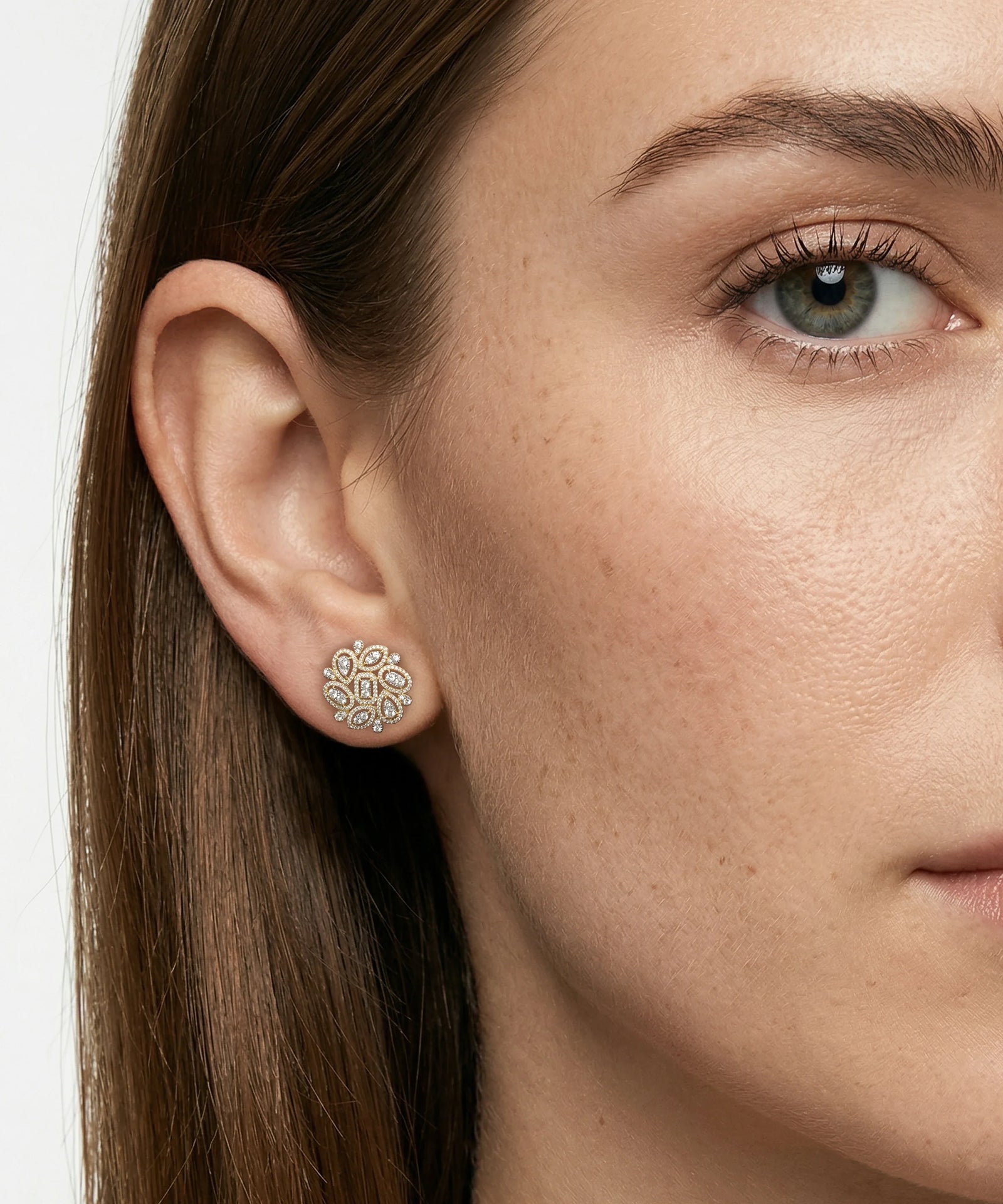 Close-up of a woman wearing a diamond earring with a neutral background