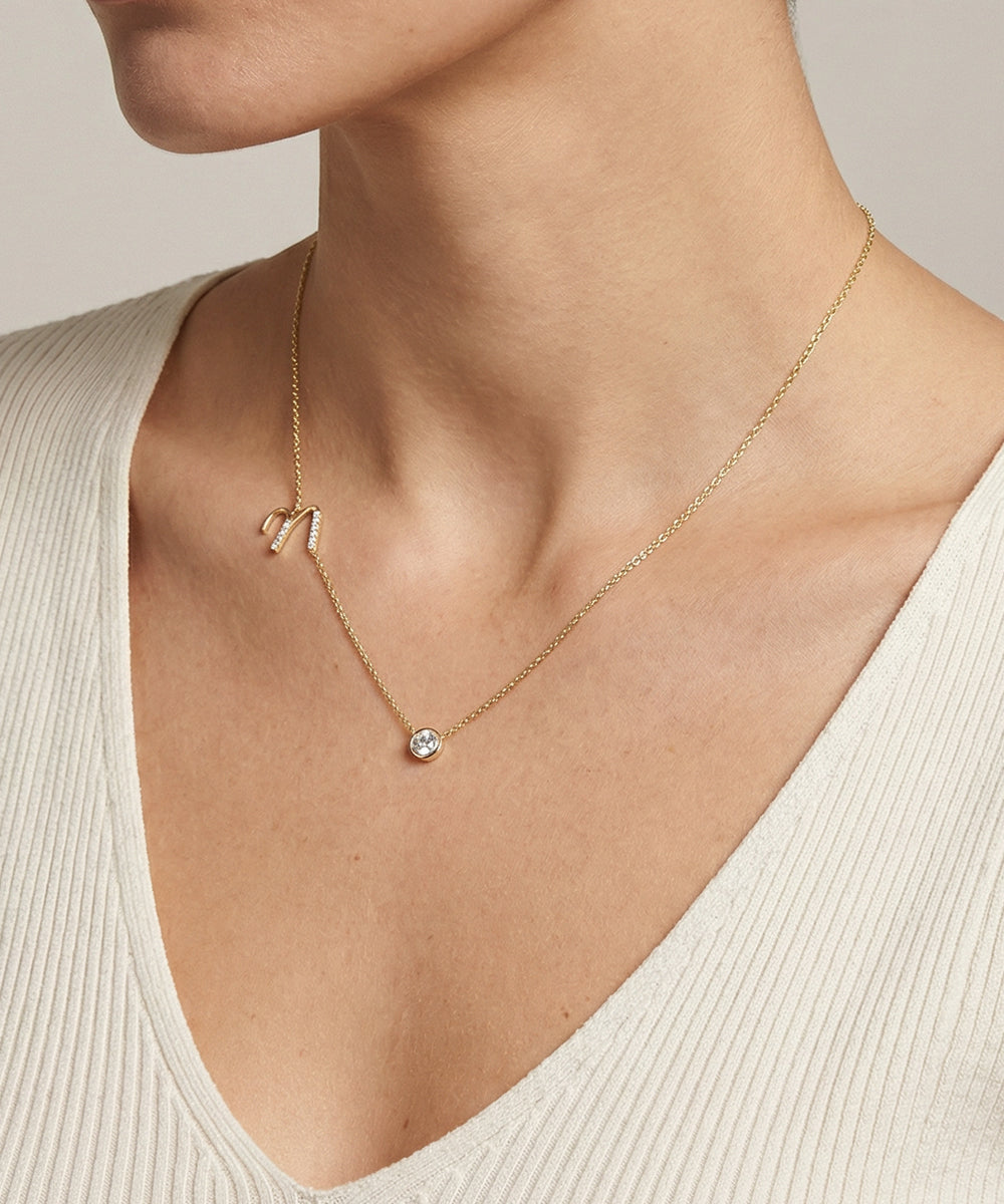 Necklace with a pendant worn by a person in a neutral setting