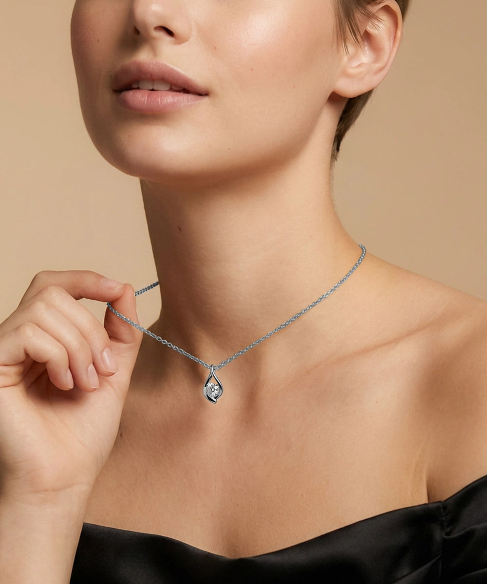 Necklace with a pendant being worn by a person against a neutral background