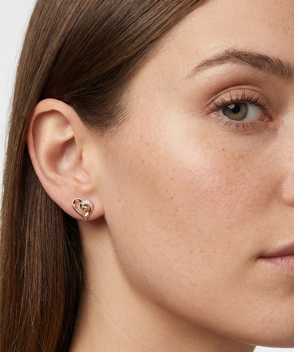 Close-up of a woman wearing a heart-shaped earring.
