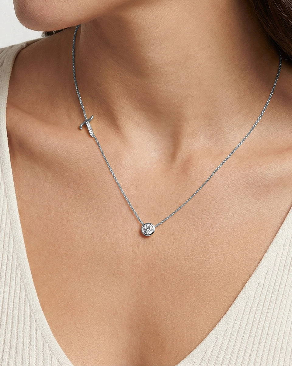 Necklace with a pendant worn by a person, focusing on the jewelry against a neutral background.