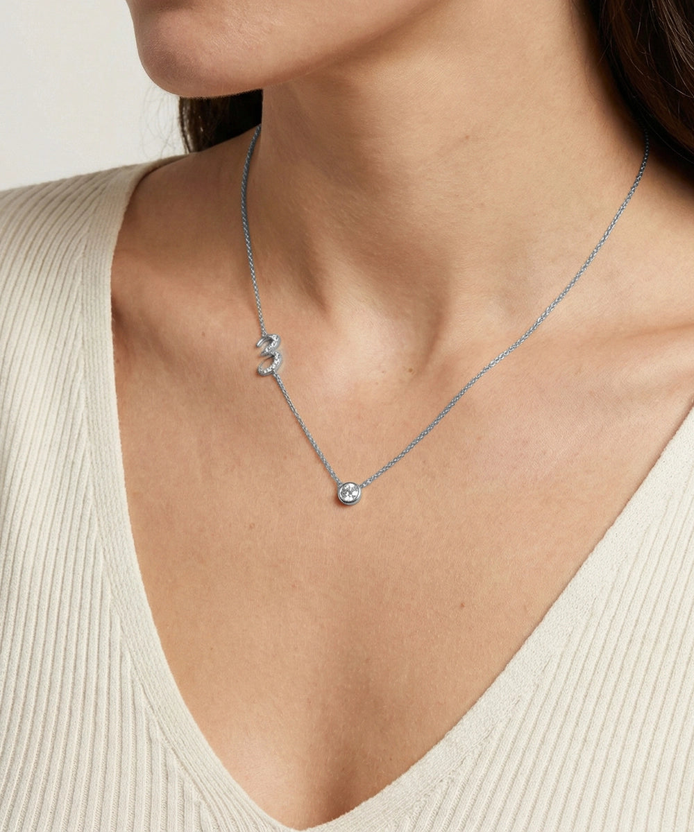 Necklace with a pendant worn by a person in a beige top