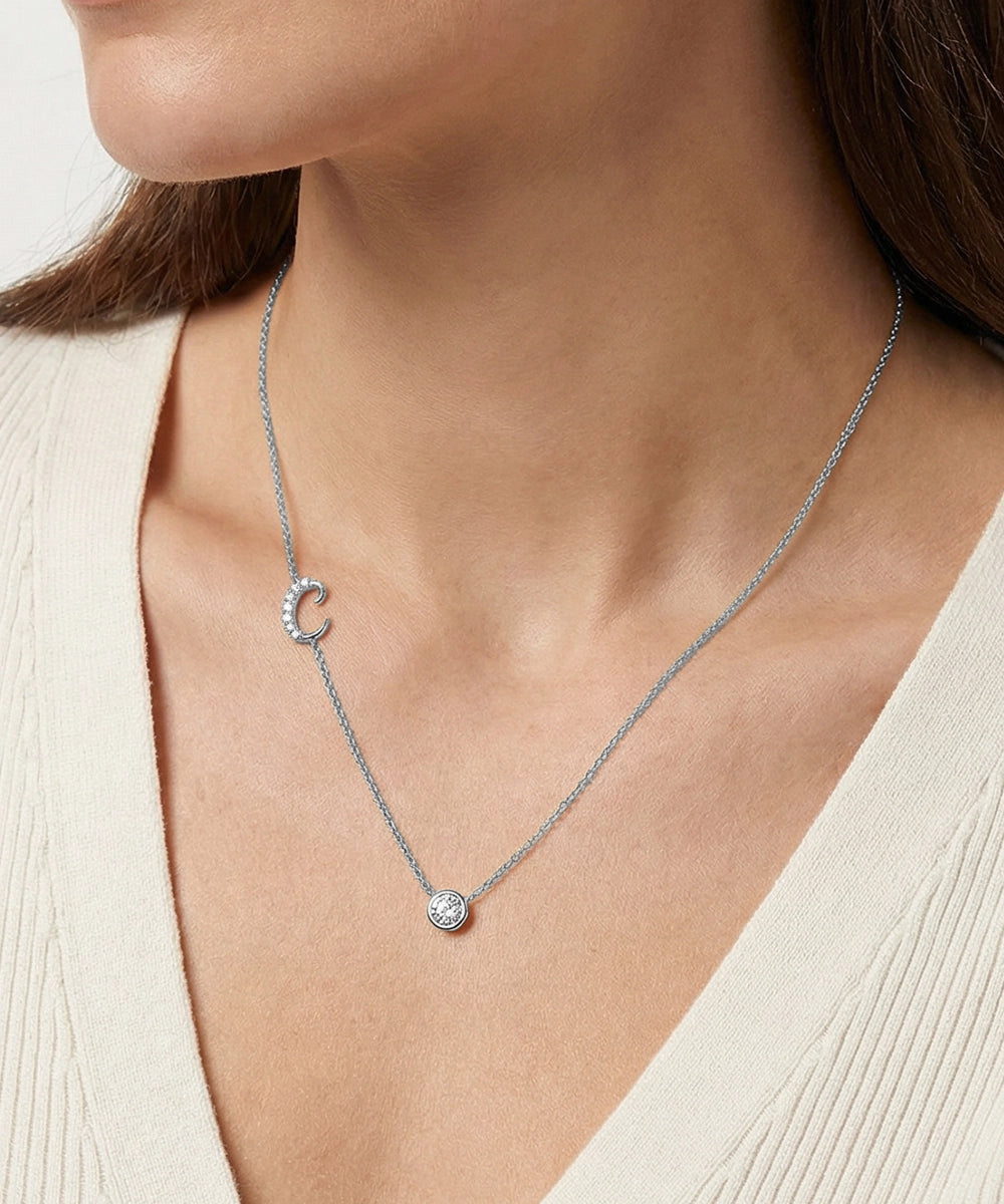 Necklace with a pendant worn by a person against a neutral background