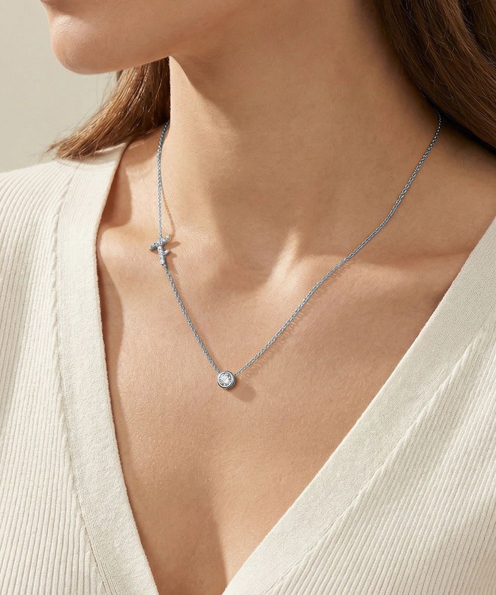 Necklace with a pendant on a person wearing a light-colored top