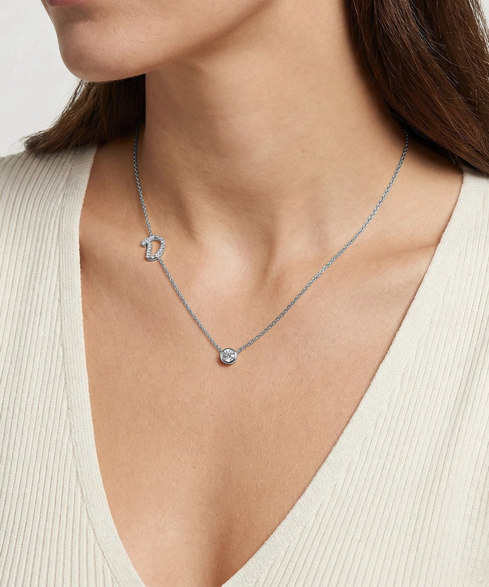 Necklace with a pendant worn by a person against a neutral background