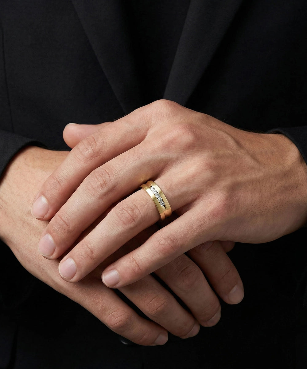 Close-up of hands with a gold ring on a black background