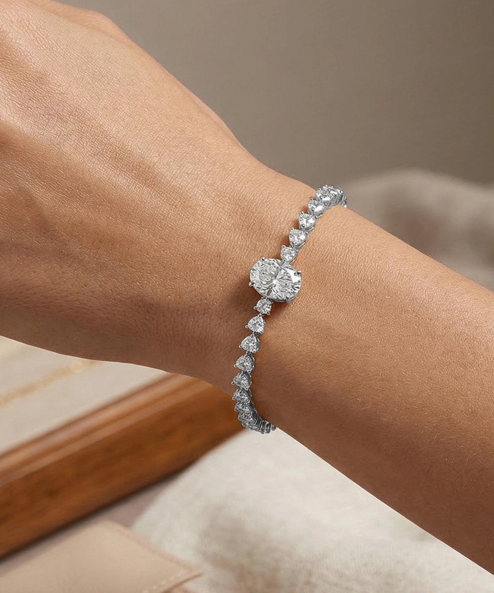 Diamond bracelet on a wrist with a neutral background