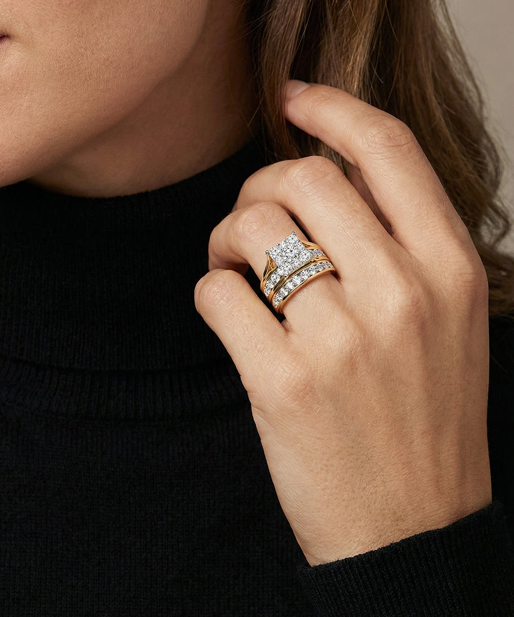 Hand wearing a diamond ring with a blurred background