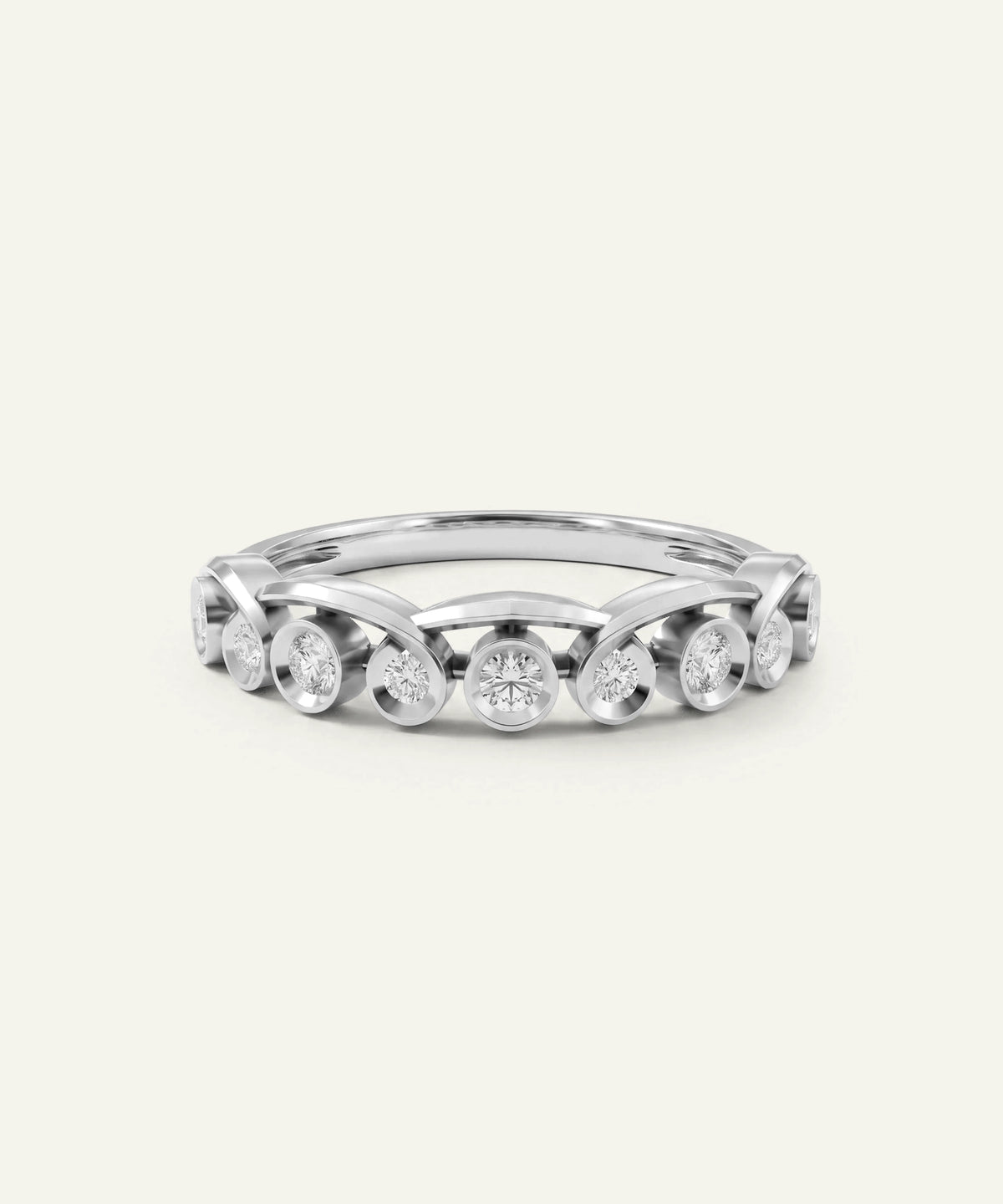 A silver-toned diamond eternity ring with a continuous row of round-cut diamonds set in a polished band, shown on a light cream background.