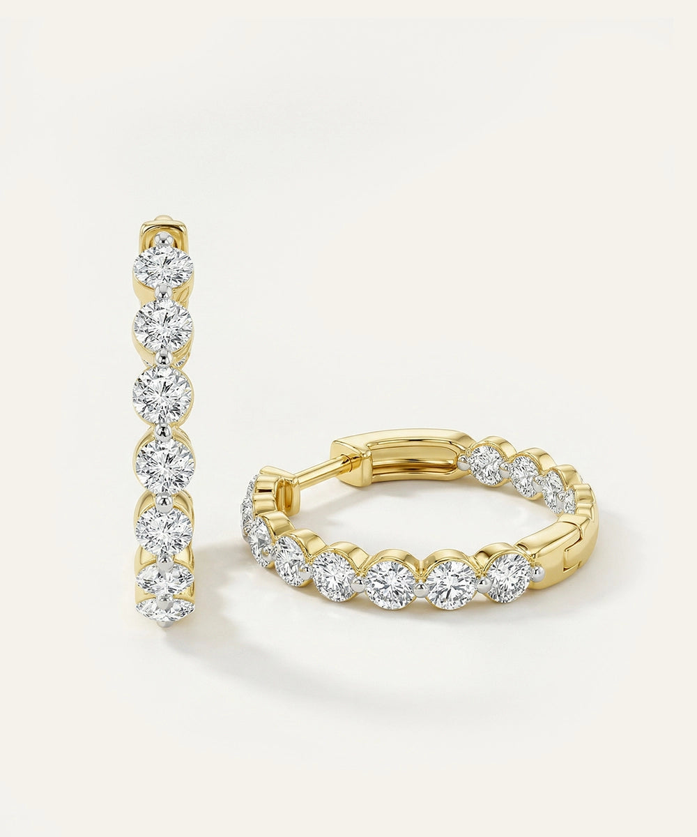 Yellow gold inside-out round diamond hoop earrings studio display.