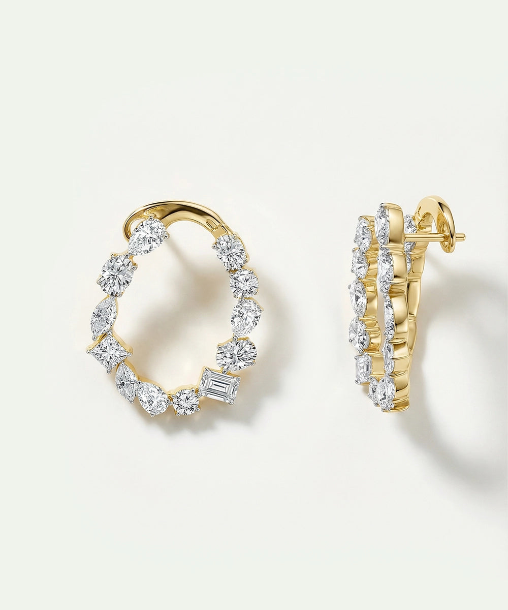 Gold hoop earrings with diamond accents on a light background