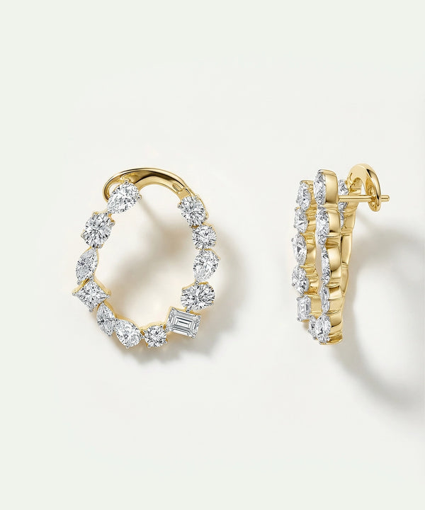 Gold hoop earrings with diamond accents on a light background