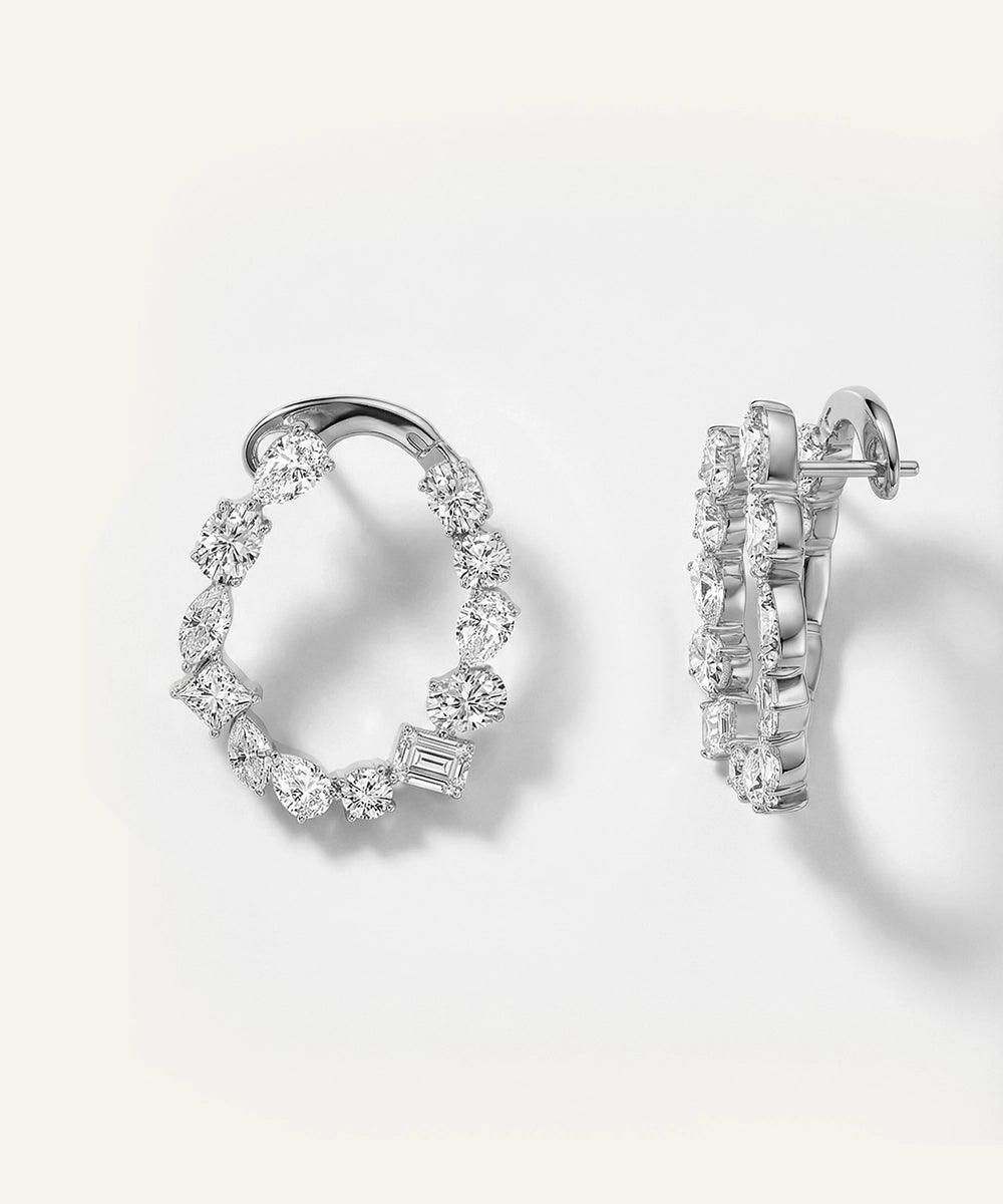 Pair of diamond hoop earrings on a light gray background